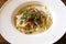 Italian cuisine, Spaghetti Cabana or Spaghetti White Sauce on white dish at restaurant