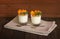 Italian dessert panna cotta with fresh apricots served in small transparent glasses. Selective focus