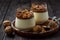 Italian dessert pannacotta in glasses with salted caramel and walnuts.