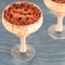 Italian dessert tiramisu in an elegant cocktail glass, the concept of sweet life, luxury, delicious food