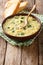 Italian egg soup stracciatella with farfalline pasta close-up. v