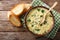 Italian egg soup stracciatella with farfalline pasta and parmesan close-up. horizontal top view