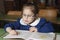 Italian elementary school girl first-grader reading on school