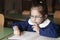 Italian elementary school girl first-grader reading on school