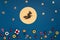 Italian Epiphany day concept. Witch Befana flying on broomstick, moon, stars and christmas sweets on dark blue background