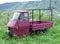 An Italian farm truck left abandoned in a field with tall grass at Civita di Bagnoregio, Italy