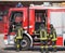 Italian firefighters climb on firetrucks during an emergency