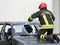 Italian firemen break the windshield of the car to release the i