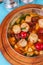 Italian fish soup with tomatoes, dough, dumplings, potatoes and greens. Mediterranean cuisine, European dish