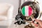 Italian flag on globe under magnifying