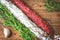 Italian flag made up of red and white salami, green sprigs thyme