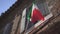 Italian flag waving on the balcony of the ancient house