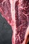 Italian Florentine T bone dry aged beef meat Steak, on black stone background, top view flat lay