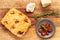 Italian focaccia with confit garlic cloves and rosemary, alongside tomatoes,  garlic bulb, parmesan cheese and rosemary twig