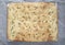 Italian focaccia - rustic local baked from flour, olive oil, yeast, sugar, salt and water, lying on an iron baking sheet against a