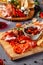 Italian food. Assortment of appetizers for a large company in a restaurant. Different types of smoked meat, sausages and cheeses.