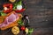 Italian food background, with meat, tomatoes, spaghetti, garlic, peppercorns, chili pepper on wood table