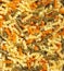 Italian food background, top view of fusilli. Textured backdrop of uncooked natural pasta. Stylish food wallpaper