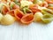 Italian food - colored uncooked conchiglie pasta