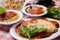 Italian food combination of lasagna, small side salad and garlic knots with whole raw vegetables  on the background