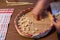 Italian food. Elderly housewife prepares the Cicciones, the traditional gnocchi of handmade pasta, typical of northern Sardinia