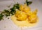 Italian food, fresh home made pumpkin stuffed pasta tortellini or ravioli dumplings with parmesan parmigiano reggiano cheese sauce