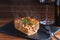 Italian food fresh hot steaming lasagna pasta served on wooden table and slate plate