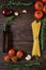 Italian food, ingredient layout for vegetarian spaghetti recipe. Whole grain pasta on a rustic dark wooden table. Recipe space in