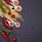 Italian food ingredients.Still life of cooking pasta on a black background top view. Wooden spoons with spices. Frame of products