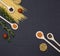 Italian food ingredients.Still life of cooking pasta on a black background top view. Wooden spoons with spices. Frame of products