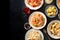 Italian food, overhead flat lay shot. Pasta, olives, wine on a black background with copy space