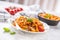 Italian food and pasta pene with bolognese sause on plate