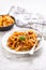 Italian food and pasta pene with bolognese sause on plate