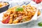 Italian food and pasta pene with bolognese sause on plate