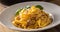 Italian food pasta tagliatelle carbonara with pancetta parmesan egg yolk and basil leaves