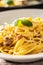 Italian food pasta tagliatelle carbonara with pancetta parmesan egg yolk and basil leaves