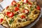 Italian food: penne pasta with mushrooms, cherry tomatoes, stuff