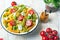 Italian food - Salad with colorful pasta, cherry tomatoes, feta cheese and fresh basil