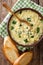 Italian food: soup stracciatella with farfalline and cheese close-up. Vertical top view