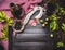 Italian food still life with bottle and a glass of red wine, olives and sausage on dark rustic background, top view