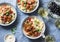 Italian food table. Pasta with slow cooker chicken with olives and sweet peppers, white wine. On a blue background