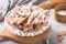 Italian Frappe or chiacchiere hvorost - typical Italian carnival fritters dusted with powdered sugar on concrete  table