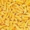 Italian Fusilli, Rotini or Scroodle Macaroni Pasta food background texture