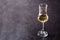 Italian golden grappa drink on black background