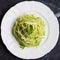 Italian green pasta spaghetti with pesto green peas, mint