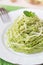Italian green pasta spaghetti with pesto green peas, mint