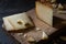 Italian hard cheese pecorino toscano sliced and chopped on wooden board