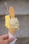 Italian Ice cream in cone - mango and pistachio - gelato in woman`s hand