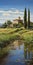 Italian Landscape: A Serene Stream Bordering A Romantically Iconic House