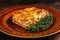 Italian Lasagne with tomato bolognese sauce and mince beef meat on a rustic plate. Dark background. Top view